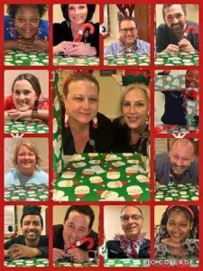 A collage of 13 people posing with a festive, holiday-themed tablecloth featuring Santa Claus prints. Each person is framed individually in a red-bordered square, smiling and engaging with holiday props such as candy canes and tinsel. The central image features two women sitting together, smiling at the camera. The overall theme is cheerful and Christmas-themed.